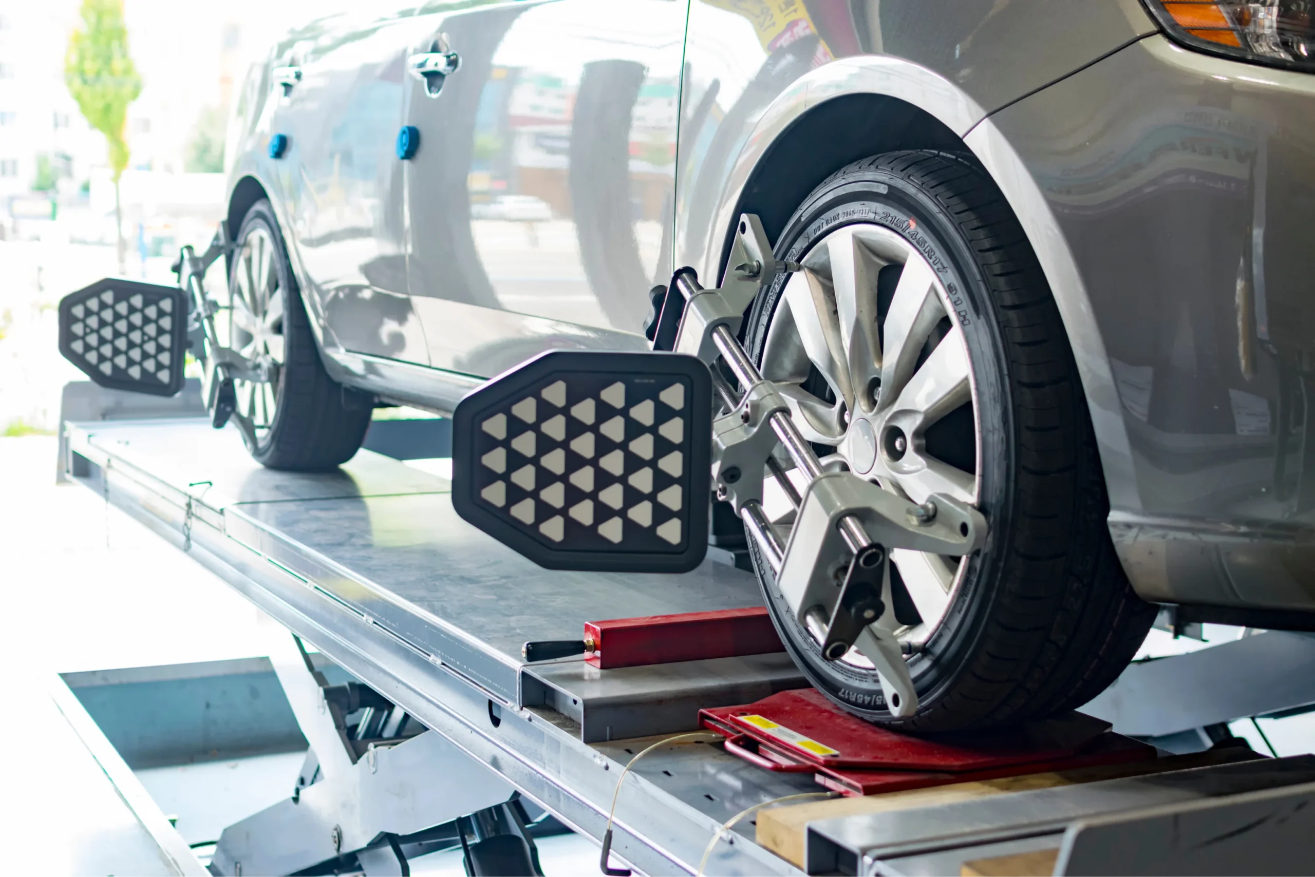 SUV set up on a wheel alignment rig